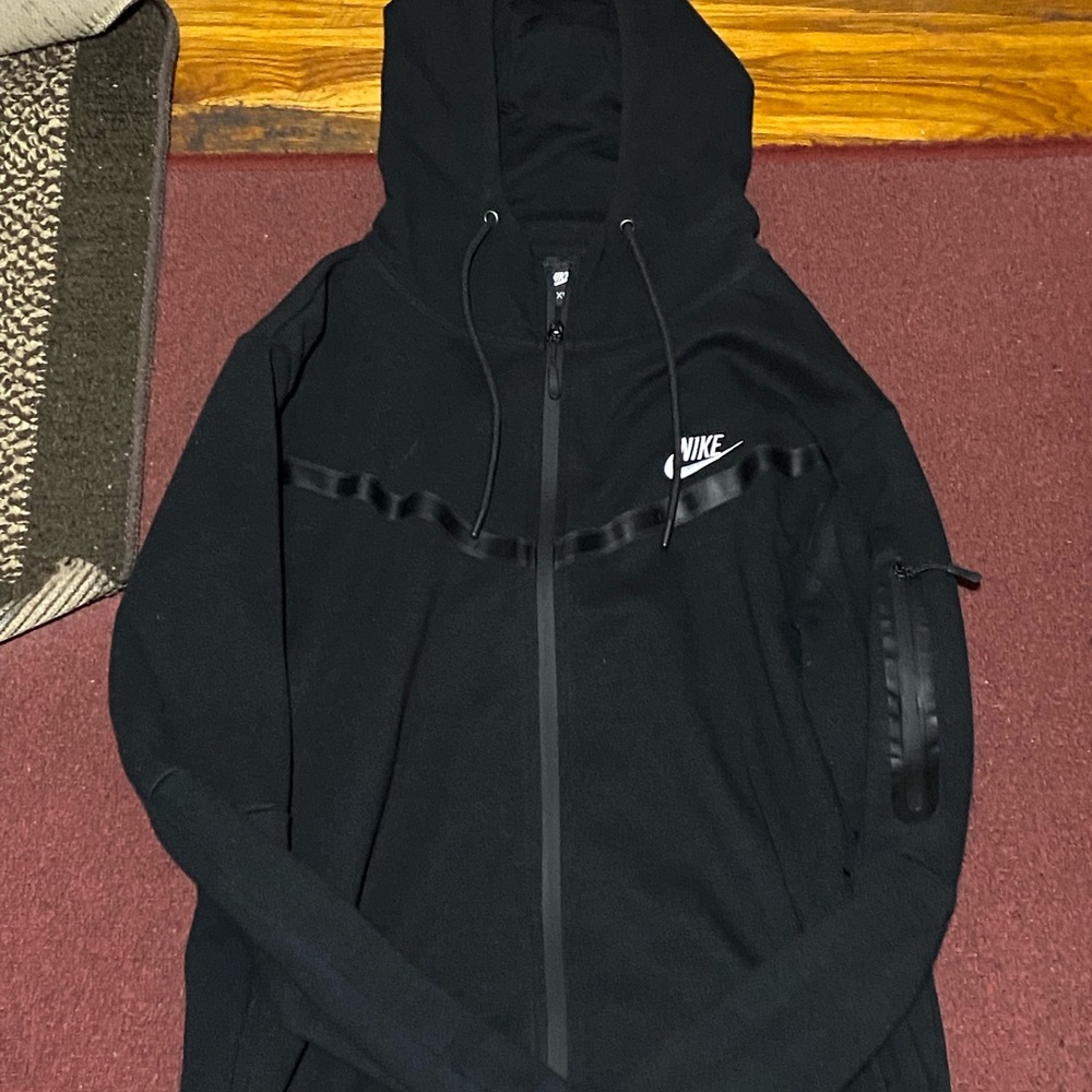 Black nike tech with white nike sign